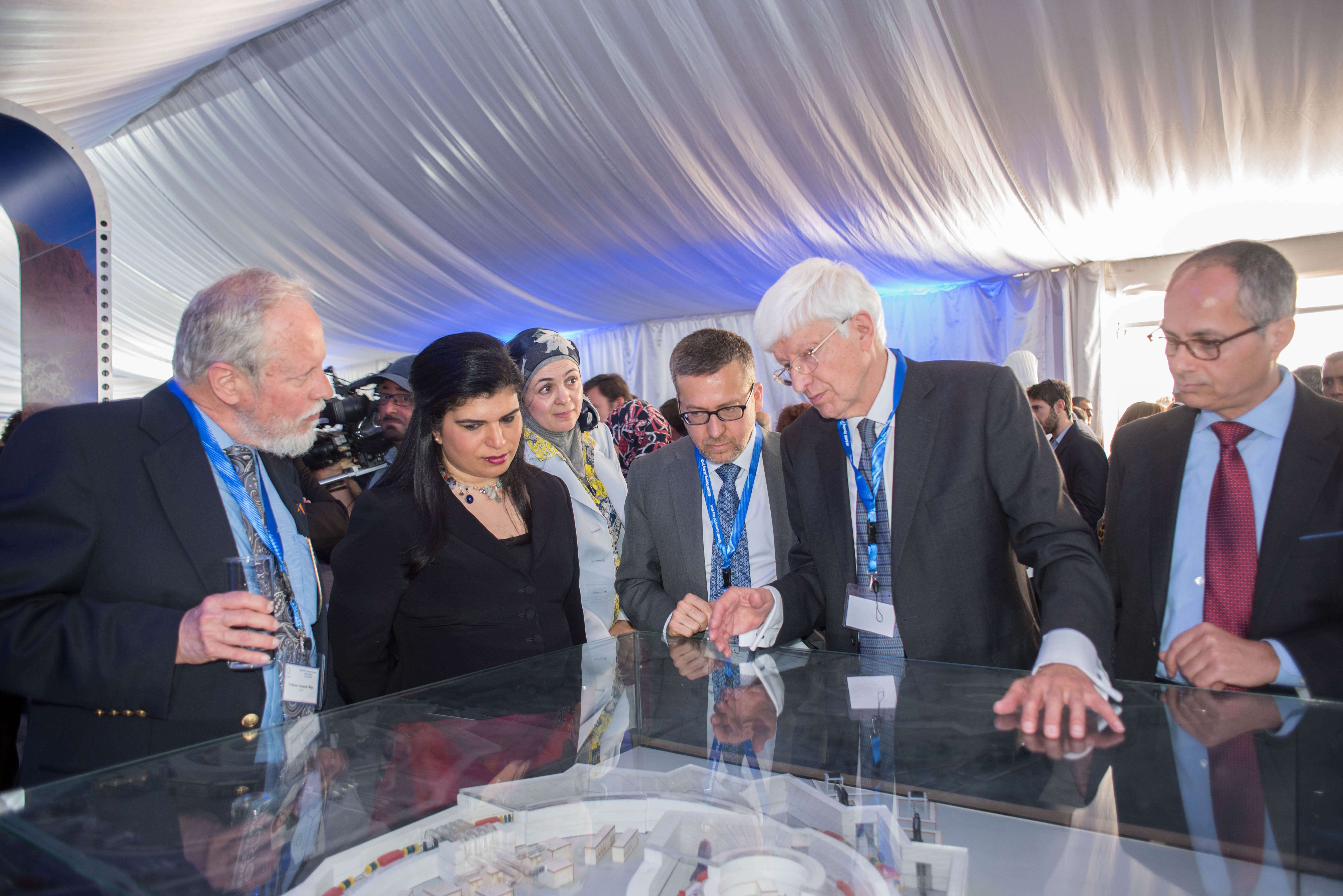 © Joe Niemela/ICTP-UNESCO: The President of the Council explaining the model of the SESAME accelerator with (on his right) the EC Commissioner for Research, Science and Innovation and HRH Princess Sumaya bint El Hassan (front)