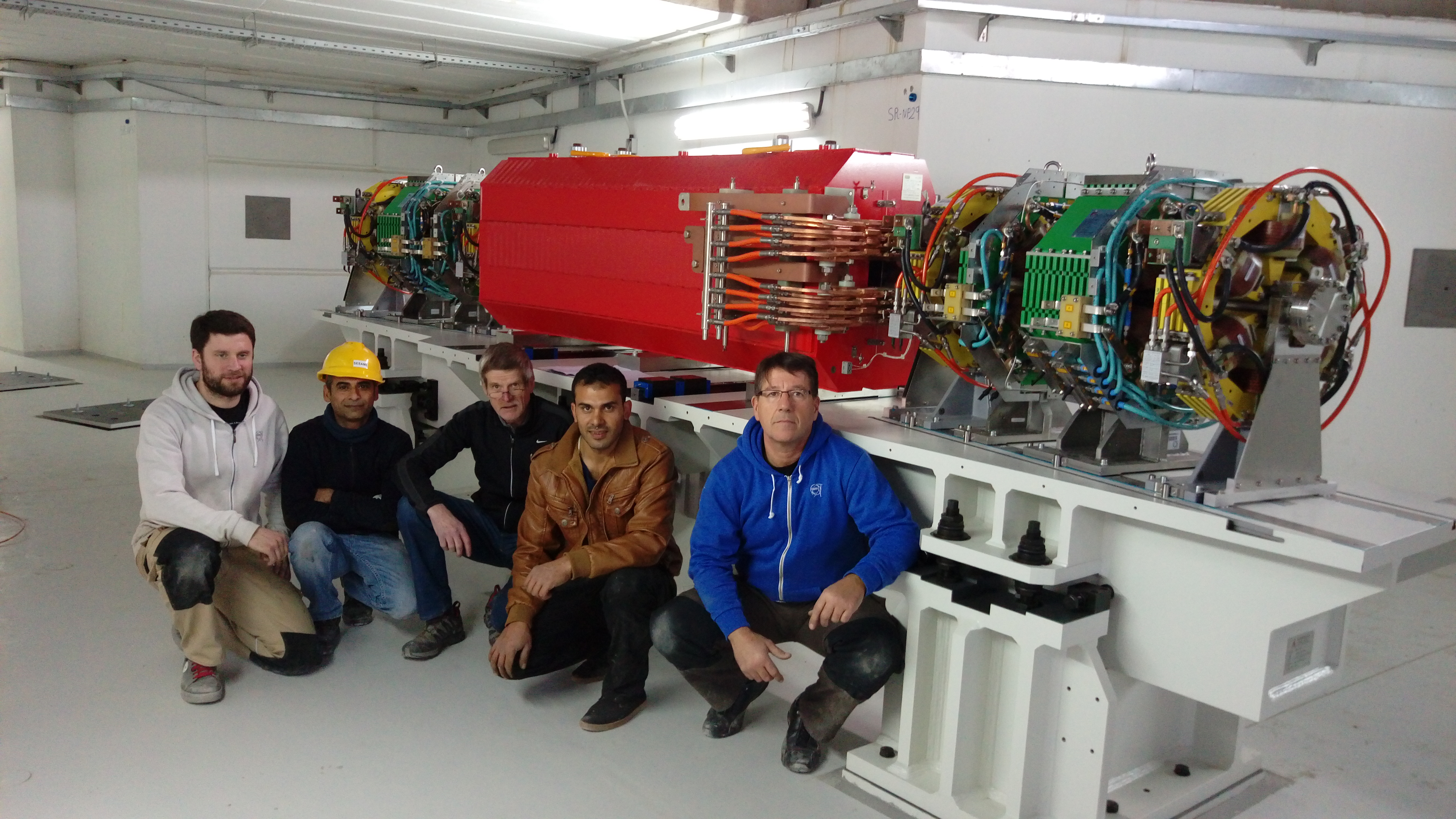 Source of the photo: © SESAME | One cell of the main storage ring installed in the shielding tunnel in the experimental hall with (left to right) Maxime Dumas (CERN), Maher Shehab, Erhard Huttel and Mohamed Khalileh (SESAME) and Carlos Lopez (CERN)