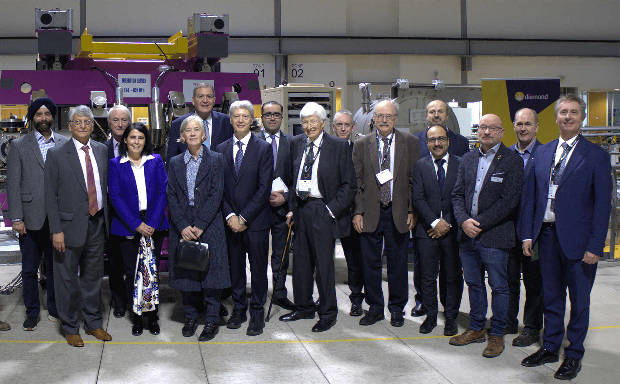 ©Diamond Light Source 2025: posing in front of the donated undulator and monochromator, left to right: Kawal Sawhney (B16 beamline), Samar Hasnain (UK representative on the SESAME Council), Richard Walker (Diamond Technical Director), Sofia Diaz-Moreno (Spectroscopy group leader), Dame Angela McLean (UK government chief scientific adviser), Khaled Toukan (Director of SESAME), Gianluigi Botton (CEO of Diamond Light Source), Faris Khreis (representative of the Jordan ambassador to the UK), Sir Chris Llewellyn-Smith (former president of SESAME Council), Michael Fitzpatrick (Diamond board member), Sir Mark Walport (foreign secretary and vice president of the Royal Society), Maher Attal (SESAME Technical Director), Adrian Mancuso (Diamond Physical Science Director), Martin Walsh (interim Diamond Life Science Director), Andy Dent, Andrea Lausi (SESAME Science Director)